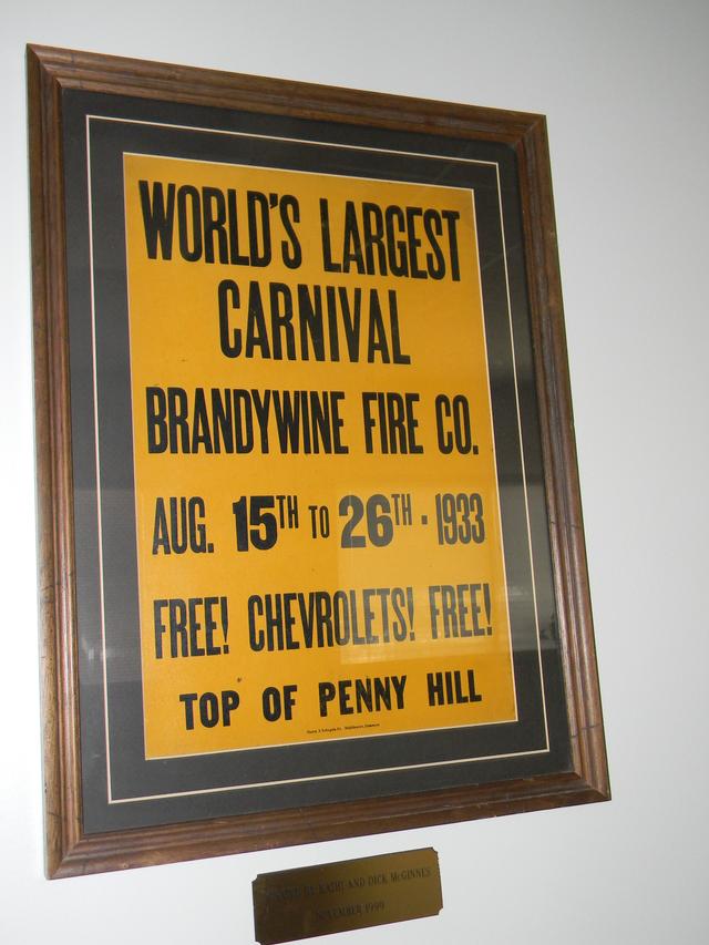 Framed Carnival poster donated by Kathi and Dick McGinnes. In conference room.